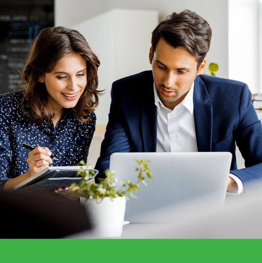 Man and woman collaborating on a project with a laptop computer